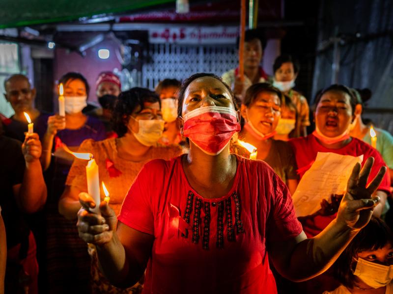 People hold candles and make a three-finger salute in a market on Feb. 5 in Yangon, Myanmar. People in Myanmar continue to take part in acts of civil disobedience in protest against the Feb. 1 military coup. People hold candles and make a three-finger salute in a market on Feb. 5 in Yangon, Myanmar. People in Myanmar continue to take part in acts of civil disobedience in protest against the Feb. 1 military coup.