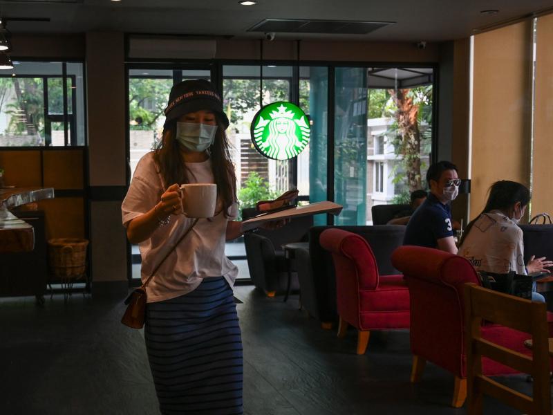 Customers wearing facial coverings at a Starbucks in Bangkok last month. In the U.S., the company is requiring employees to wear coverings starting Tuesday. Customers wearing facial coverings at a Starbucks in Bangkok last month. In the U.S., the company is requiring employees to wear coverings starting Tuesday.