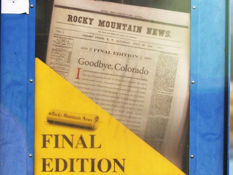 A copy of the final edition of the Rocky Mountain News sits in a newspaper box on a street corner in Denver, Colorado. A copy of the final edition of the Rocky Mountain News sits in a newspaper box on a street corner in Denver, Colorado.