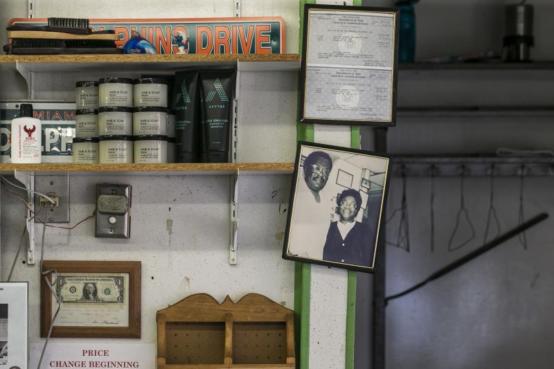A 1980s photo of Carlton and Juanita Collins hangs inside the barbershop in the same spot it was taken. A 1980s photo of Carlton and Juanita Collins hangs inside the barbershop in the same spot it was taken.