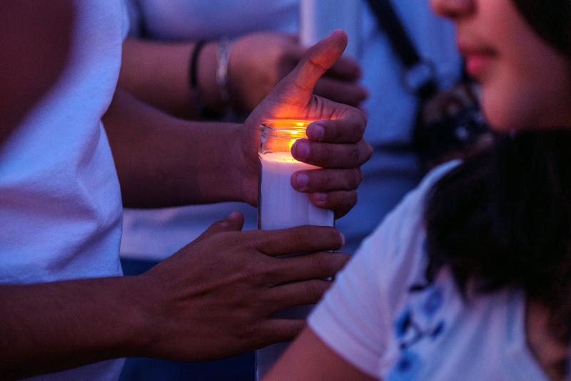 Mourners hold candles as they gather for a vigil at a memorial outside Cielo Vista Walmart in El Paso, Texas, U.S., on Wednesday, Aug. 7, 2019. Mourners hold candles as they gather for a vigil at a memorial outside Cielo Vista Walmart in El Paso, Texas, U.S., on Wednesday, Aug. 7, 2019.
