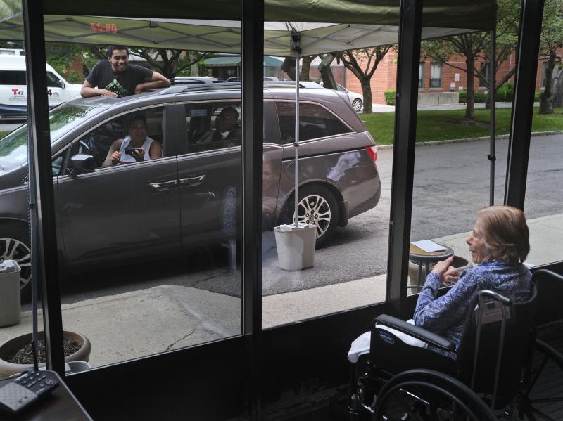 Gloria DeSoto, 92, right, visits with her family, in their car, from a window of the Hebrew Home at Riverdale, in New York, last month. Gloria DeSoto, 92, right, visits with her family, in their car, from a window of the Hebrew Home at Riverdale, in New York, last month.