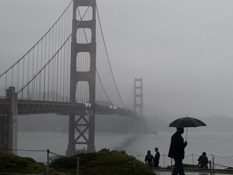 A pedestrian walks with an umbrella near the Golden Gate Bridge in San Francisco during a shower on Wednesday. Strong storms are expected to bring substantial rain to the Western U.S. within the next week. A pedestrian walks with an umbrella near the Golden Gate Bridge in San Francisco during a shower on Wednesday. Strong storms are expected to bring substantial rain to the Western U.S. within the next week.