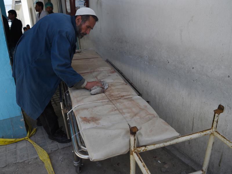 An Afghan member of medical staff cleans a stretcher following a suicide bombing attack in Kabul on April 22, 2018. (Photo by WAKIL KOHSAR / AFP) (Photo credit should read WAKIL KOHSAR/AFP/Getty Images) An Afghan member of medical staff cleans a stretcher following a suicide bombing attack in Kabul on April 22, 2018. (Photo by WAKIL KOHSAR / AFP) (Photo credit should read WAKIL KOHSAR/AFP/Getty Images)