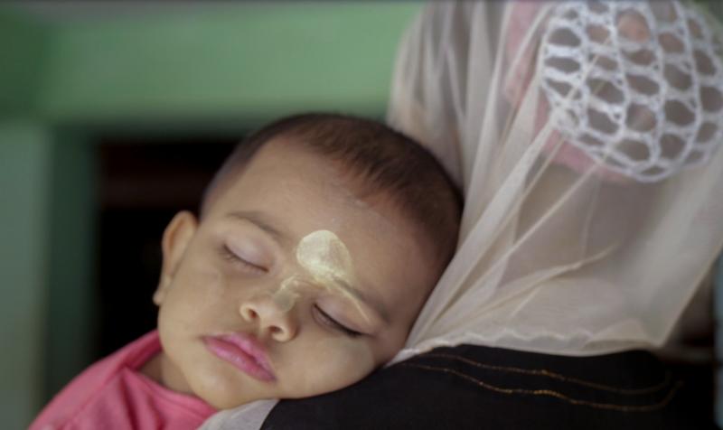 A scene from Midwives: A baby whose face is adorned with thanaka — a kind of sunscreen made from wood bark. A scene from Midwives: A baby whose face is adorned with thanaka — a kind of sunscreen made from wood bark.