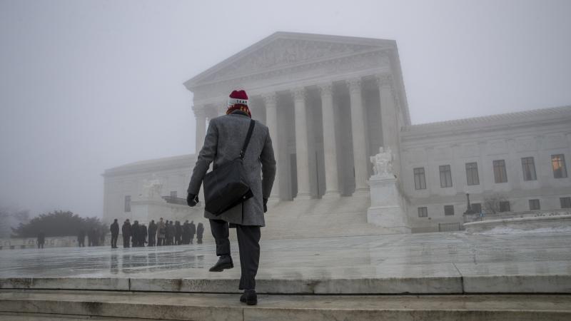 A man walks up in the fog at the U.S. Supreme Court to attend arguments last month. Justices issued multiple opinions on Wednesday. A man walks up in the fog at the U.S. Supreme Court to attend arguments last month. Justices issued multiple opinions on Wednesday.