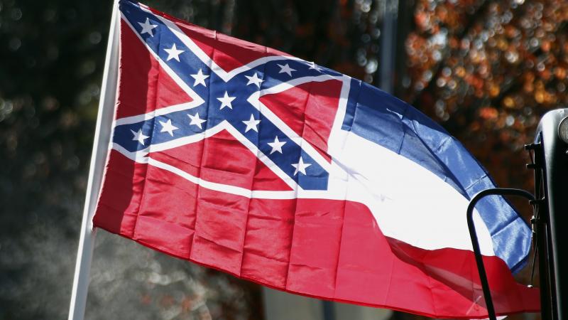 A state flag of Mississippi is unfurled by Sons of Confederate Veterans and other groups in 2016 on the grounds of the state Capitol in Jackson, Miss. A state flag of Mississippi is unfurled by Sons of Confederate Veterans and other groups in 2016 on the grounds of the state Capitol in Jackson, Miss.