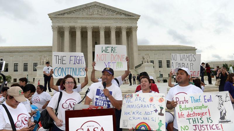People attend an immigration rally outside the Supreme Court in June. People attend an immigration rally outside the Supreme Court in June.