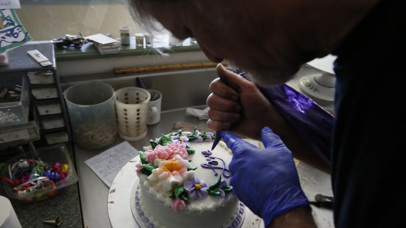 In this March 10, 2014, photo, Masterpiece Cakeshop owner Jack Phillips decorates a cake inside his store, in Lakewood, Colo. In this March 10, 2014, photo, Masterpiece Cakeshop owner Jack Phillips decorates a cake inside his store, in Lakewood, Colo.