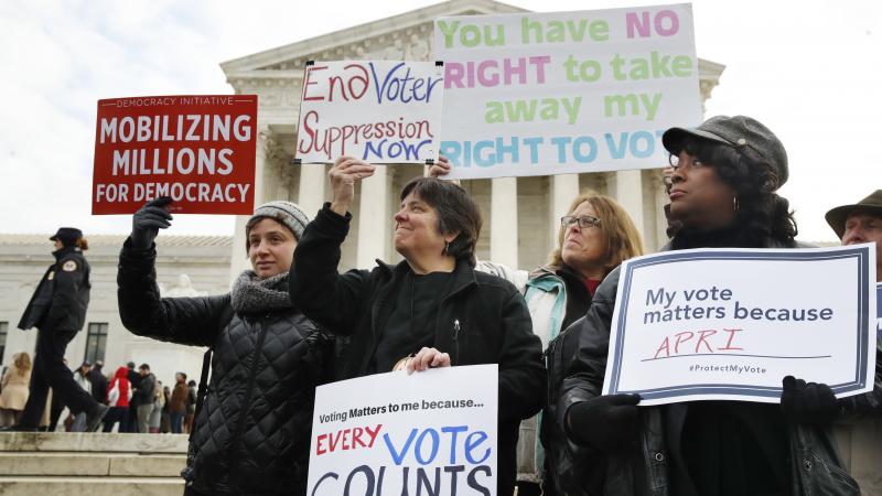 People rally outside of the Supreme Court in opposition to Ohio's voter roll purges in January. The court upheld the controversial law Monday. People rally outside of the Supreme Court in opposition to Ohio's voter roll purges in January. The court upheld the controversial law Monday.