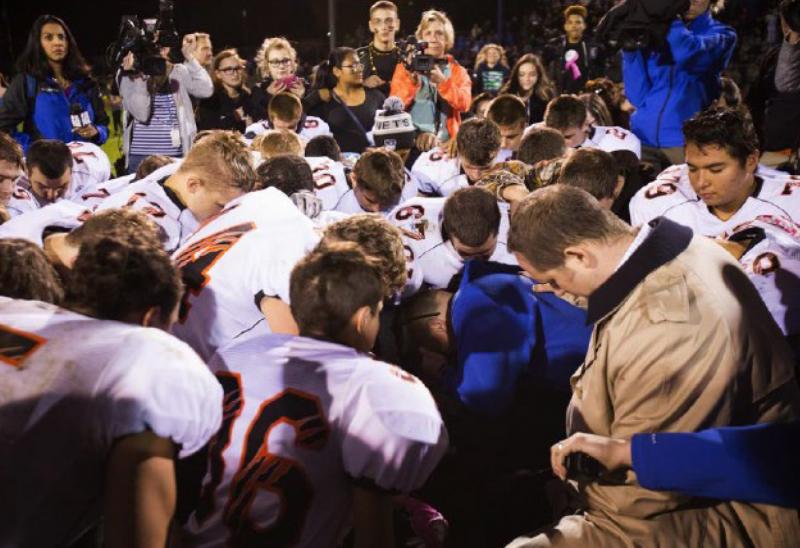 The parties included this image, of Coach Kennedy praying with a crowd after the homecoming game, in their joint appendix submitted to the Supreme Court The parties included this image, of Coach Kennedy praying with a crowd after the homecoming game, in their joint appendix submitted to the Supreme Court