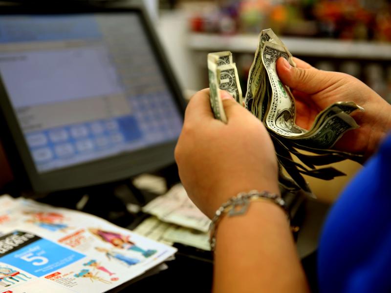 A cashier counts money at a Toys "R" Us in Los Angeles last November. A pinch in earnings and hours disappointed those looking for a pickup in paychecks last month. A cashier counts money at a Toys "R" Us in Los Angeles last November. A pinch in earnings and hours disappointed those looking for a pickup in paychecks last month.