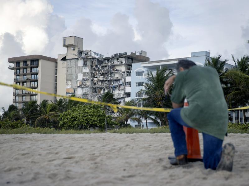 A man prays Friday near where search and rescue operations are ongoing at the partially collapsed 12-story Champlain Towers South condo building in Surfside, Fla. A man prays Friday near where search and rescue operations are ongoing at the partially collapsed 12-story Champlain Towers South condo building in Surfside, Fla.