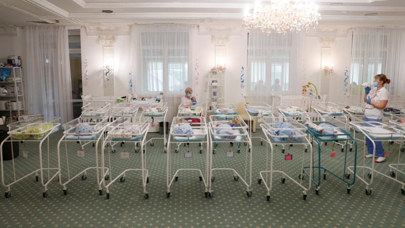 Nurses and newborns in Hotel Venice, a facility owned by BioTexCom clinic in Kyiv, Ukraine, on Thursday. Dozens of babies born to surrogate mothers are stranded in Ukraine as the coronavirus restrictions prevent foreign parents from collecting them. Nurses and newborns in Hotel Venice, a facility owned by BioTexCom clinic in Kyiv, Ukraine, on Thursday. Dozens of babies born to surrogate mothers are stranded in Ukraine as the coronavirus restrictions prevent foreign parents from collecting them.