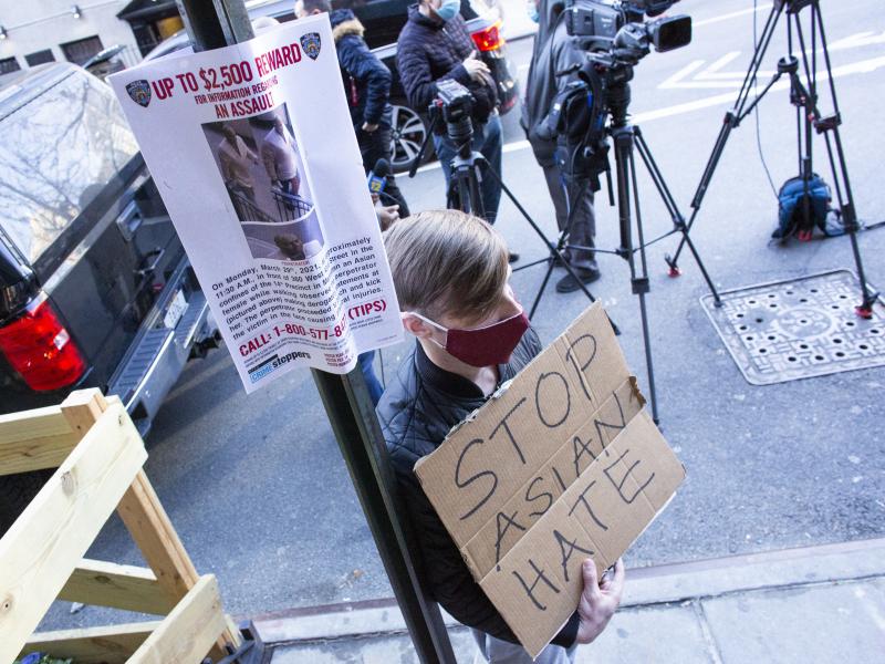 A man holds a sign at an Asian American anti-violence press conference on Tuesday, outside the building where a 65-year-old Asian woman was physically and verbally attacked in New York City. Police said Wednesday that Brandon Elliot, 38, had been arrested A man holds a sign at an Asian American anti-violence press conference on Tuesday, outside the building where a 65-year-old Asian woman was physically and verbally attacked in New York City. Police said Wednesday that Brandon Elliot, 38, had been arrested