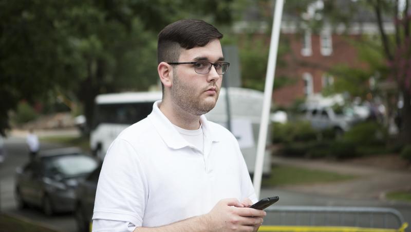 James Alex Fields Jr. stands on the sidewalk ahead of a rally in Charlottesville, Va., on Aug. 12, 2017. He is accused of ramming his car into a crowd of counterprotesters later that day, killing 32-year-old Heather Heyer. James Alex Fields Jr. stands on the sidewalk ahead of a rally in Charlottesville, Va., on Aug. 12, 2017. He is accused of ramming his car into a crowd of counterprotesters later that day, killing 32-year-old Heather Heyer.