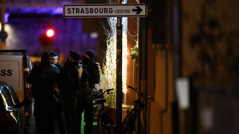Police officers stand near the place where Cherif Chekatt, the alleged gunman who had been a fugitive since allegedly killing three people at a popular Christmas market in Strasbourg, France, was shot dead by police on Thursday. Police officers stand near the place where Cherif Chekatt, the alleged gunman who had been a fugitive since allegedly killing three people at a popular Christmas market in Strasbourg, France, was shot dead by police on Thursday.