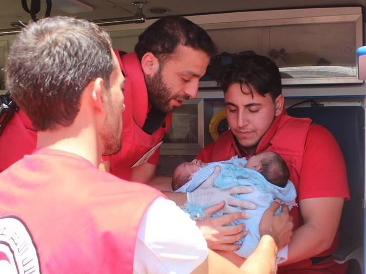 A Syrian Red Crescent team works to evacuate the conjoined twins to a hospital in Damascus on Friday. A Syrian Red Crescent team works to evacuate the conjoined twins to a hospital in Damascus on Friday.