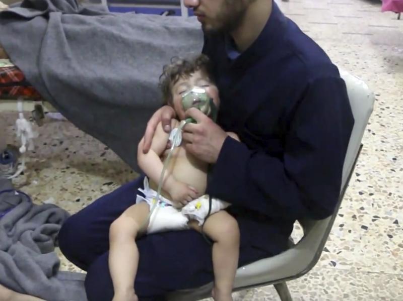 This image made from video shows a medical worker administering oxygen through respirators following an alleged poison gas attack in Douma. The Syrian government denied the allegations. This image made from video shows a medical worker administering oxygen through respirators following an alleged poison gas attack in Douma. The Syrian government denied the allegations.