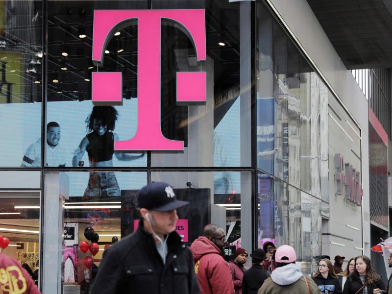 Pedestrians walk past a T-Mobile store in New York City on Friday. Sprint and T-Mobile are seeking to merge, but the proposed deal sill requires regulatory approval. Pedestrians walk past a T-Mobile store in New York City on Friday. Sprint and T-Mobile are seeking to merge, but the proposed deal sill requires regulatory approval.