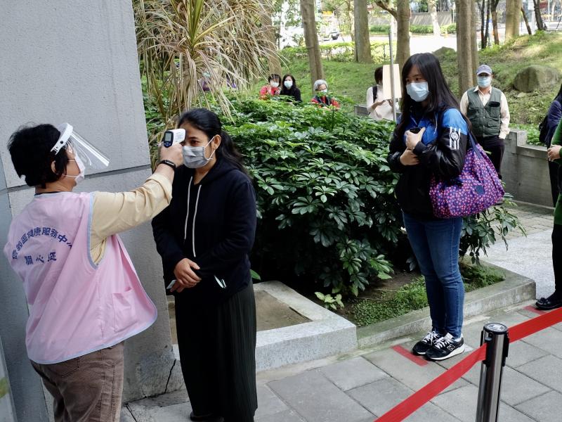 People line up for temperature checks at the Xinyi District Health Center in Taipei on April 14. People line up for temperature checks at the Xinyi District Health Center in Taipei on April 14.