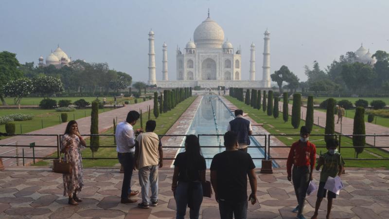 Tourists visit the Taj Mahal on Monday, when it reopened after being closed for more than six months due to the coronavirus pandemic. Tourists visit the Taj Mahal on Monday, when it reopened after being closed for more than six months due to the coronavirus pandemic.