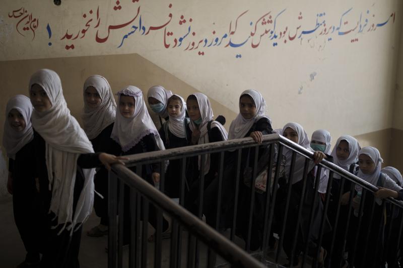 Girls enter a school before class in Kabul on Sept. 12, 2021. In a surprise decision, the hardline leadership of Afghanistan's new rulers has decided against opening educational institutions to girls beyond sixth grade. Girls enter a school before class in Kabul on Sept. 12, 2021. In a surprise decision, the hardline leadership of Afghanistan's new rulers has decided against opening educational institutions to girls beyond sixth grade.