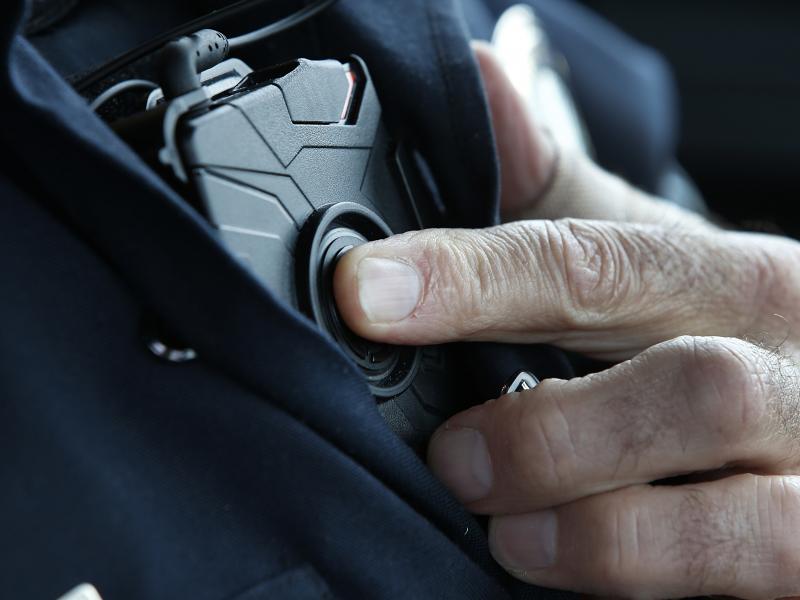 A patrol officer in West Valley City, Utah, starts a body camera recording by pressing a button on his chest in March 2015. The West Valley City Police Department issued 190 Axon Flex body cameras for all its sworn officers to wear. A patrol officer in West Valley City, Utah, starts a body camera recording by pressing a button on his chest in March 2015. The West Valley City Police Department issued 190 Axon Flex body cameras for all its sworn officers to wear.