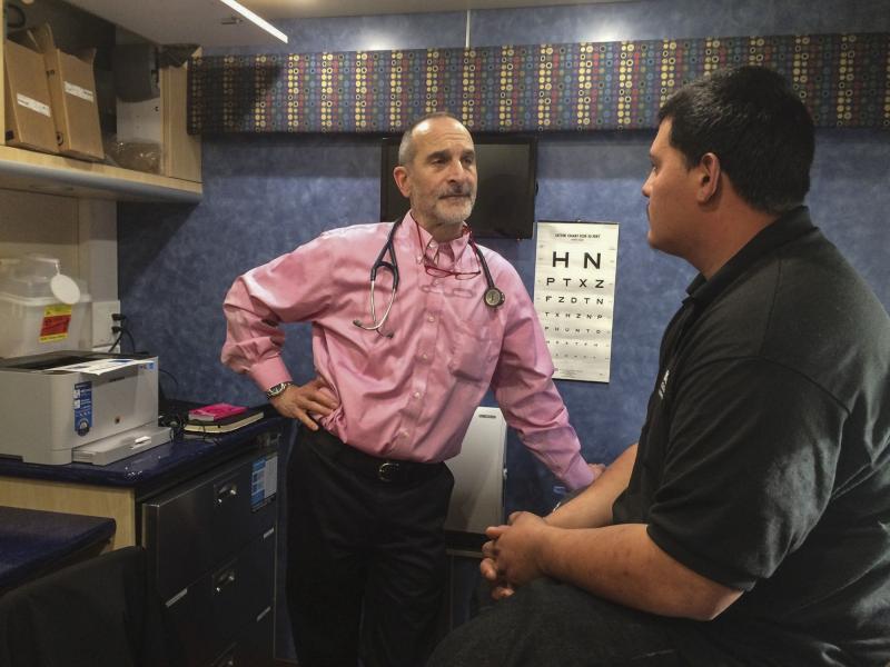 Inside a mobile clinic parked near a Conservation Corp high school, Dr. Seth Ammerman talks with a patient. About 400 young people who visit the van each year have never seen a doctor, Ammerman says. Inside a mobile clinic parked near a Conservation Corp high school, Dr. Seth Ammerman talks with a patient. About 400 young people who visit the van each year have never seen a doctor, Ammerman says.