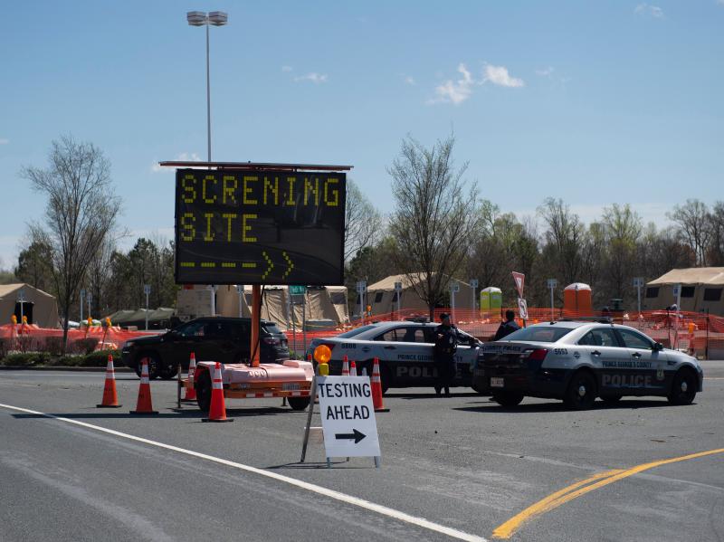 Healthcare professionals screen people at a testing site organized by the Maryland National Guard in a parking lot at FedEx Field on March 30, 2020 in Landover, Md. Healthcare professionals screen people at a testing site organized by the Maryland National Guard in a parking lot at FedEx Field on March 30, 2020 in Landover, Md.