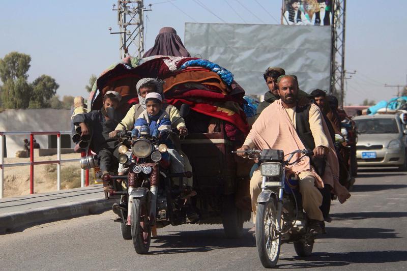 Afghans flee to Lashkar Gah, Helmand's provincial capital, during fighting between Taliban and Afghan security forces on Monday. Local authorities estimate that some 35,000 people have been displaced into Lashkar Gah since a Taliban offensive began in Hel Afghans flee to Lashkar Gah, Helmand's provincial capital, during fighting between Taliban and Afghan security forces on Monday. Local authorities estimate that some 35,000 people have been displaced into Lashkar Gah since a Taliban offensive began in Hel