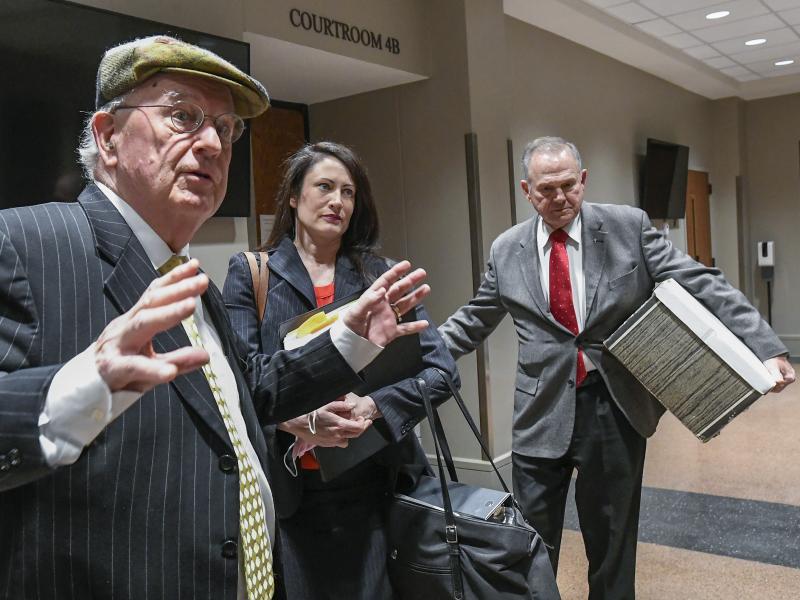 Former Alabama Chief Justice Roy Moore, right, and his attorney Julian McPhillips, left, leave the courtroom in Montgomery, Ala., on Monday following jury selection. Moore and Leigh Corfman, who accused him of sexual assault, are suing each other for defa Former Alabama Chief Justice Roy Moore, right, and his attorney Julian McPhillips, left, leave the courtroom in Montgomery, Ala., on Monday following jury selection. Moore and Leigh Corfman, who accused him of sexual assault, are suing each other for defa