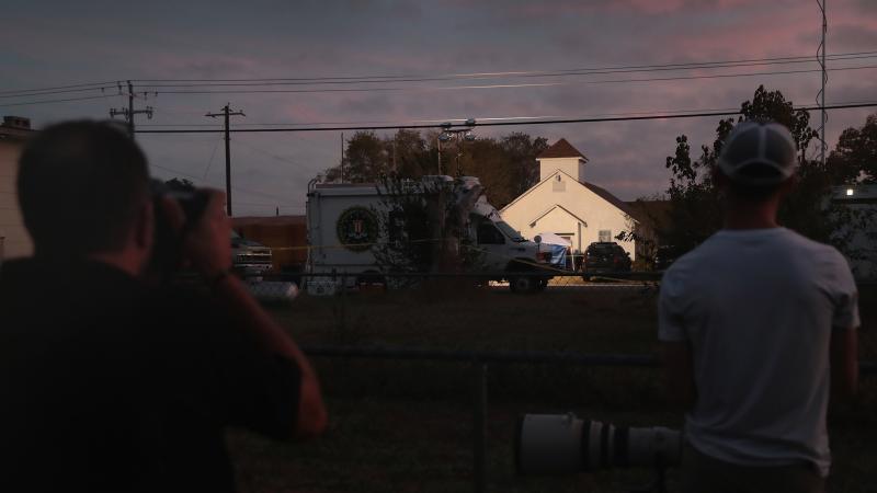 Newspaper photographers look on as the sun rises over the First Baptist Church in Sutherland Springs, Texas, the site of a mass shooting during a Sunday service. Newspaper photographers look on as the sun rises over the First Baptist Church in Sutherland Springs, Texas, the site of a mass shooting during a Sunday service.