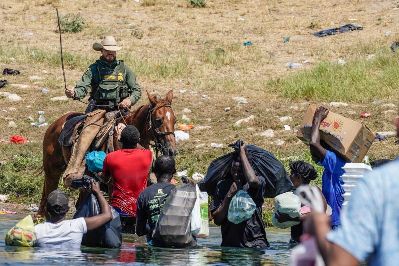 A United States Border Patrol agent on horseback uses the reins as he tries to stop Haitian migrants from entering an encampment on the banks of the Rio Grande near the Acuna Del Rio International Bridge in Del Rio, Texas on September 19, 2021. A United States Border Patrol agent on horseback uses the reins as he tries to stop Haitian migrants from entering an encampment on the banks of the Rio Grande near the Acuna Del Rio International Bridge in Del Rio, Texas on September 19, 2021.