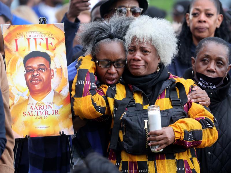 People participate in a vigil to honor the 10 people killed in Saturday's shooting at Tops market in Buffalo, New York. People participate in a vigil to honor the 10 people killed in Saturday's shooting at Tops market in Buffalo, New York.