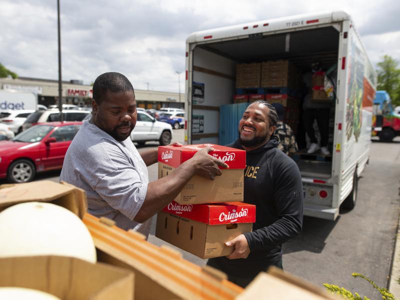 Pastor Andre Kamoche, left, and Greg Jackson, with Rehoboth House of Prayer, help unload a truck of fresh produce to be given out to people affected by the Tops closure on Tuesday in Buffalo, N.Y. Pastor Andre Kamoche, left, and Greg Jackson, with Rehoboth House of Prayer, help unload a truck of fresh produce to be given out to people affected by the Tops closure on Tuesday in Buffalo, N.Y.