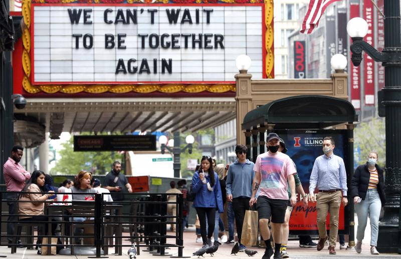 People walk near the Chicago Theatre on Tuesday in the city's Loop community. The Centers for Disease Control and Prevention eased its guidelines on the wearing of masks, saying fully vaccinated Americans don't need to cover their faces anymore in most se People walk near the Chicago Theatre on Tuesday in the city's Loop community. The Centers for Disease Control and Prevention eased its guidelines on the wearing of masks, saying fully vaccinated Americans don't need to cover their faces anymore in most se