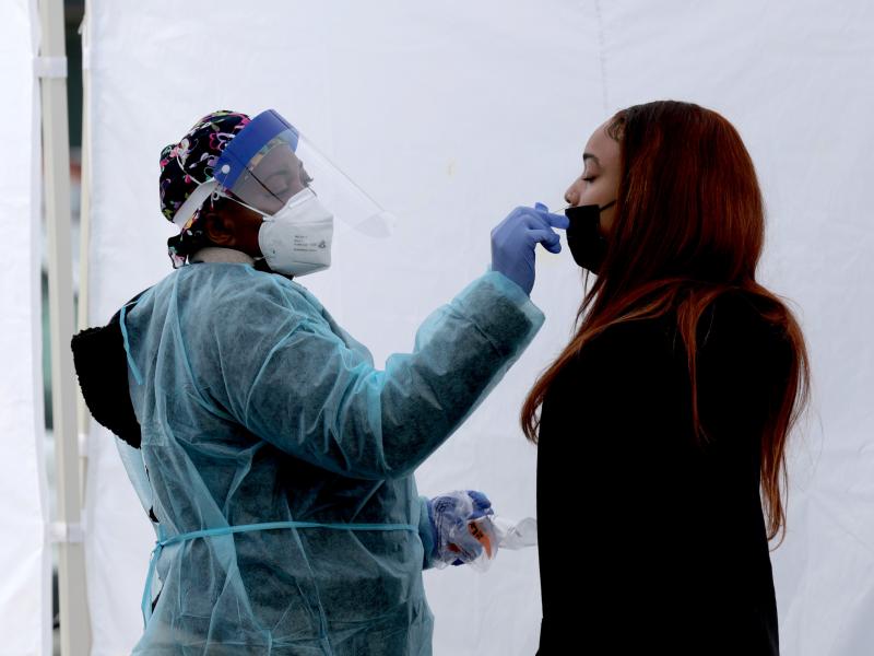 A healthcare worker administers a COVID-19 PCR test at a free test site in Farragut Square on Dec. 28 in Washington, D.C. On Tuesday, the CDC revised data reflecting the prevalence of the omicron variant in new COVID-19 cases. A healthcare worker administers a COVID-19 PCR test at a free test site in Farragut Square on Dec. 28 in Washington, D.C. On Tuesday, the CDC revised data reflecting the prevalence of the omicron variant in new COVID-19 cases.