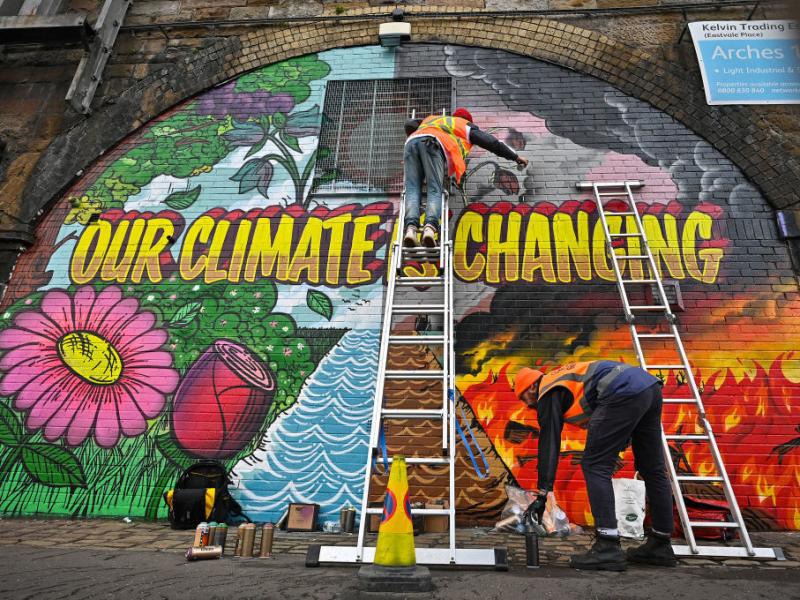Artists paint a mural on a wall near Scottish Events Centre (SEC) in Glasgow, which will host the U.N. climate summit starting Sunday. Artists paint a mural on a wall near Scottish Events Centre (SEC) in Glasgow, which will host the U.N. climate summit starting Sunday.