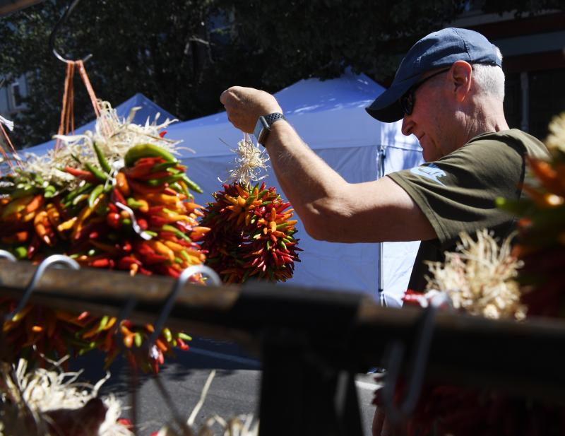 Geoff Walser picks out a ristra, a wreath-like decoration made from dried chiles, to purchase at the annual Pueblo Chile and Frijoles Festival, which draws thousands of chile lovers from Colorado and beyond. Geoff Walser picks out a ristra, a wreath-like decoration made from dried chiles, to purchase at the annual Pueblo Chile and Frijoles Festival, which draws thousands of chile lovers from Colorado and beyond.