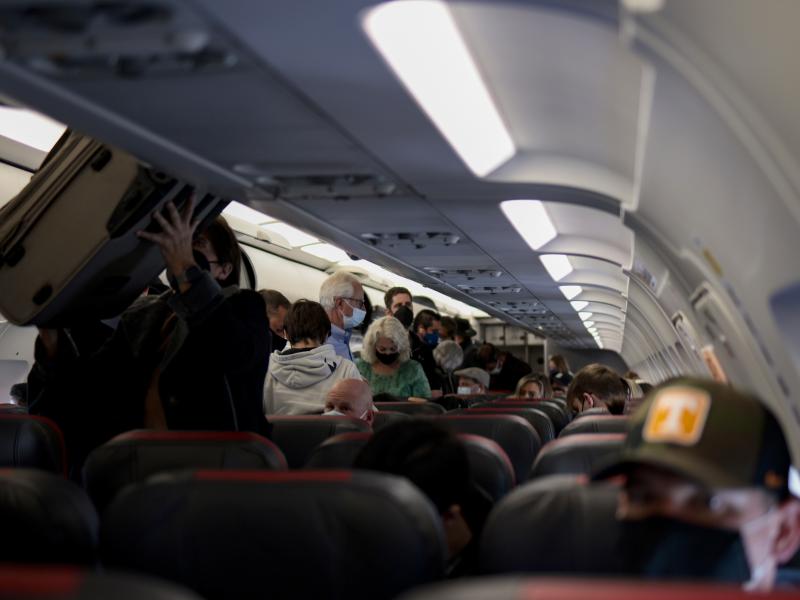 Passengers deplane from an airplane after landing at the Albuquerque International Sunport on Nov. 24, 2021 in Albuquerque, New Mexico. Passengers deplane from an airplane after landing at the Albuquerque International Sunport on Nov. 24, 2021 in Albuquerque, New Mexico.