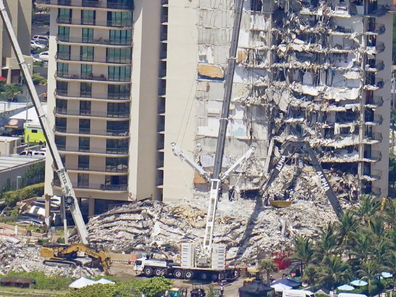 Crews work near a open tunnel, center near the bottom, in the rubble at the Champlain Towers South Condo on Sunday in Surfside, Fla. More than 150 people were still unaccounted for two days after Thursday's collapse. Crews work near a open tunnel, center near the bottom, in the rubble at the Champlain Towers South Condo on Sunday in Surfside, Fla. More than 150 people were still unaccounted for two days after Thursday's collapse.
