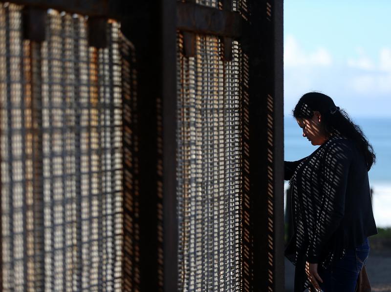 A visitor stands next to the U.S.-Mexico border fence at Friends of Friendship Park on Feb. 4 in San Ysidro, Calif. A visitor stands next to the U.S.-Mexico border fence at Friends of Friendship Park on Feb. 4 in San Ysidro, Calif.
