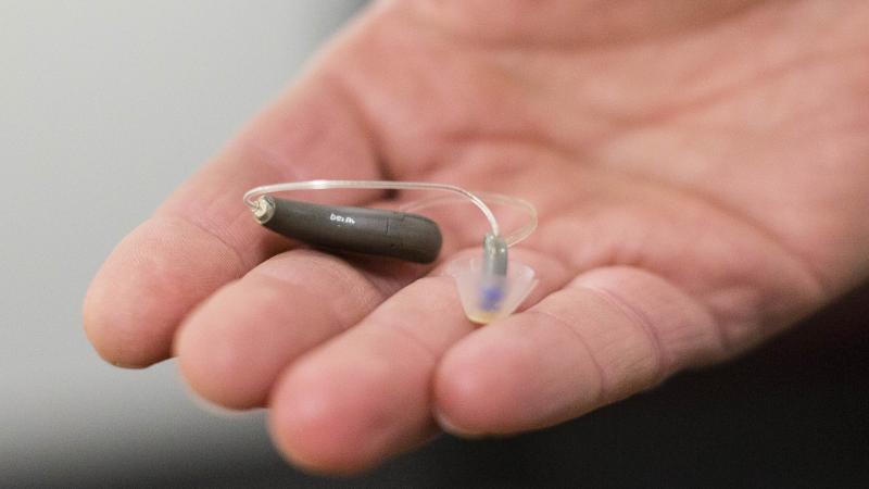 The Food and Drug Administration is moving to approve over-the-counter hearing aids in a change that lawmakers and advocates have long called for. Here, a man displays his hearing aid before taking part in a meeting. The Food and Drug Administration is moving to approve over-the-counter hearing aids in a change that lawmakers and advocates have long called for. Here, a man displays his hearing aid before taking part in a meeting.