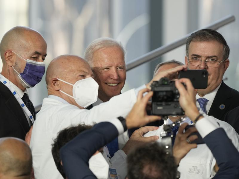 President Biden poses for a selfie with first responders who joined world leaders Saturday for the traditional family photo at the G-20 summit in Rome. President Biden poses for a selfie with first responders who joined world leaders Saturday for the traditional family photo at the G-20 summit in Rome.