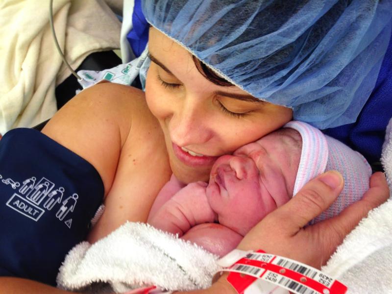 Kristen Caminiti cuddles her son Connor while doctors stitch her up following a C-section. Kristen Caminiti cuddles her son Connor while doctors stitch her up following a C-section.