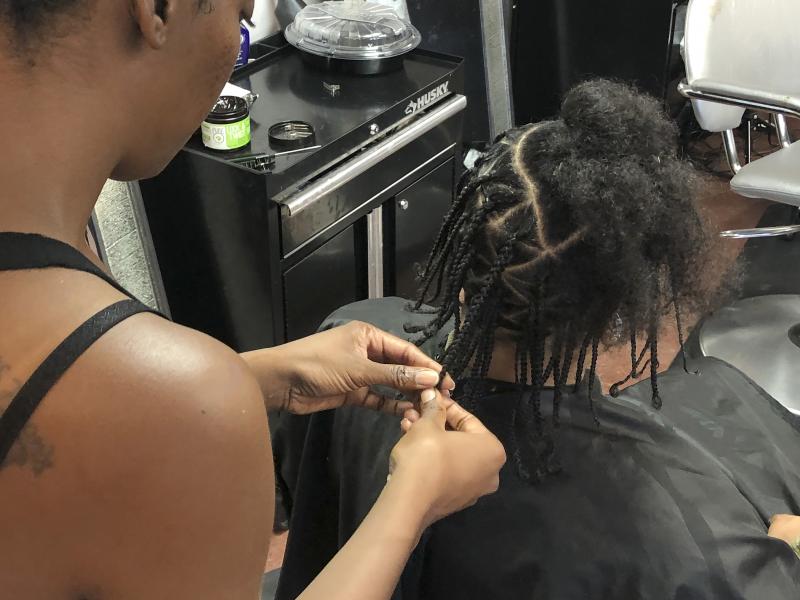 Shana Bonner, left, styles the hair of Pho Gibson at Exquisite U hair salon in this July 3, 2019, file photo. The U.S. House passed a federal anti-bias bill to protect against discrimination of race-based hairstyles. Shana Bonner, left, styles the hair of Pho Gibson at Exquisite U hair salon in this July 3, 2019, file photo. The U.S. House passed a federal anti-bias bill to protect against discrimination of race-based hairstyles.