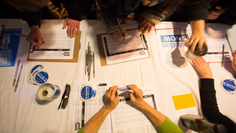 Guests sign in for a Bernie Sanders campaign event in Marshalltown, Iowa, in January. One big question is whether Sanders and outsider Donald Trump, who have been attracting large crowds, can get their supporters to caucus. Guests sign in for a Bernie Sanders campaign event in Marshalltown, Iowa, in January. One big question is whether Sanders and outsider Donald Trump, who have been attracting large crowds, can get their supporters to caucus.