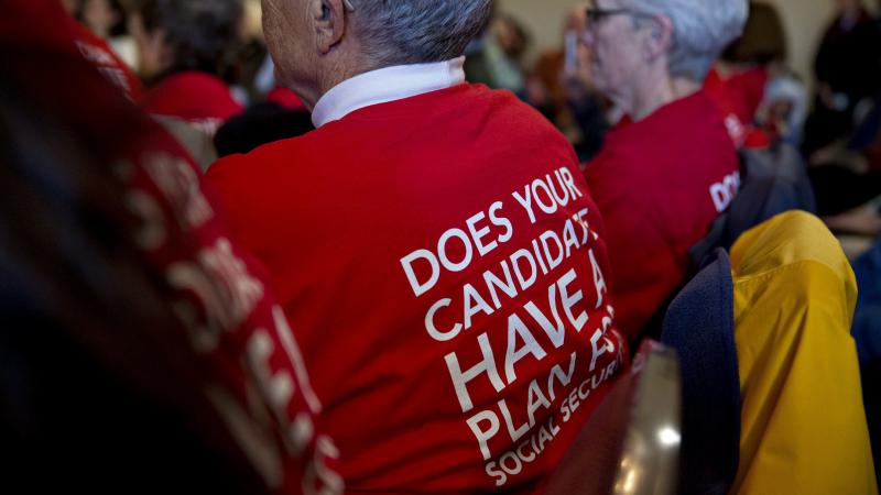 Attendees wear t-shirts in support of presidential candidates committing to Social Security for all generations during a town hall meeting in Cedar Rapids, Iowa, on Jan. 29. Attendees wear t-shirts in support of presidential candidates committing to Social Security for all generations during a town hall meeting in Cedar Rapids, Iowa, on Jan. 29.