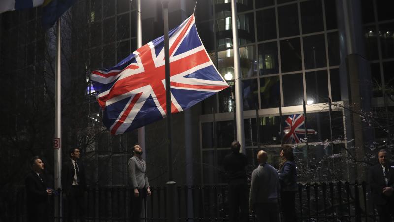 Officials lower and remove the Union Jack from the European Parliament building in Brussels on Friday. As the U.K. prepared to bring to an end its decades-long membership in the European Union, the bloc's top officials on Friday pledged to continue playin Officials lower and remove the Union Jack from the European Parliament building in Brussels on Friday. As the U.K. prepared to bring to an end its decades-long membership in the European Union, the bloc's top officials on Friday pledged to continue playin